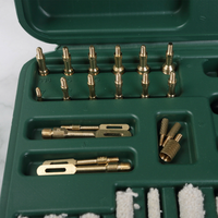 Close up picture of brass adapters of theGun Werkz 58 piece rifle and pistol cleaning kit in a green plastic case 