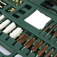 Close up picture of brushes and cotton mops of Gun Werkz 58 piece rifle and pistol cleaning kit in a green plastic case 