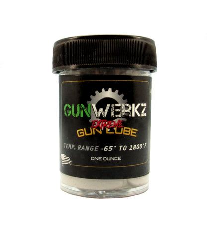 A jar of Gun-Werkz Extreme Gun Lube with a label indicating its use for gun parts, a temperature range, and that it comes with five small brushes. The jar is black with white and red text.